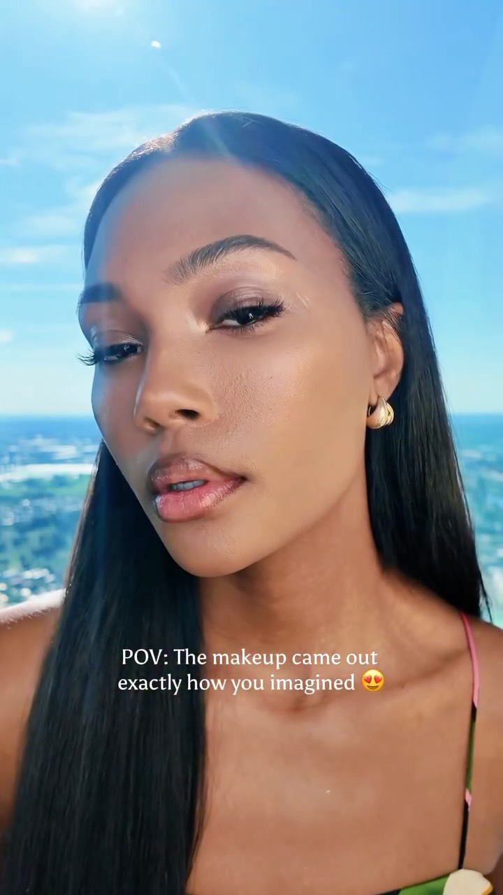 A beauty creator applying bronzy makeup for a summer glow look