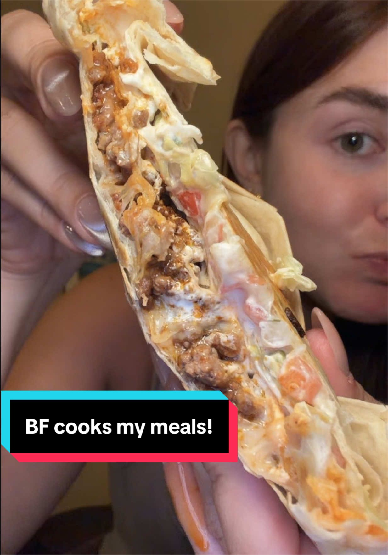 A close-up of a folded, crispy homemade crunchwrap being cut in half